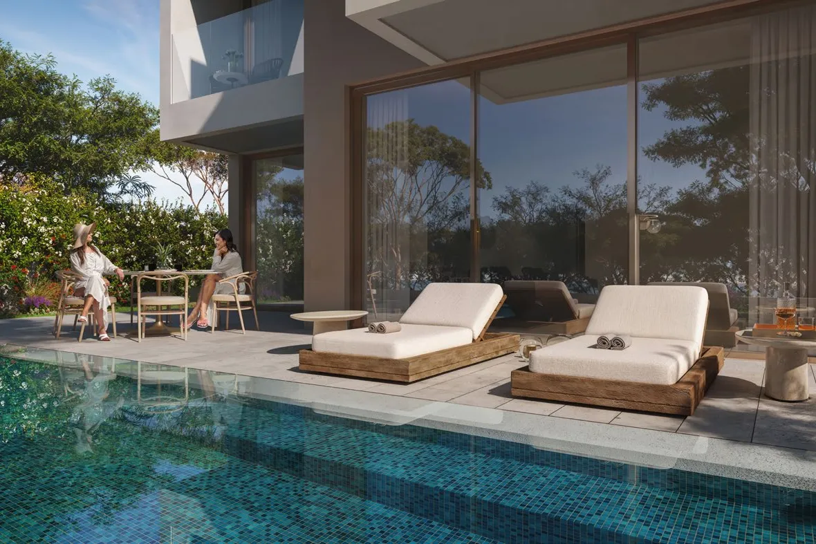 Terrace with sun loungers beside a tiled private pool