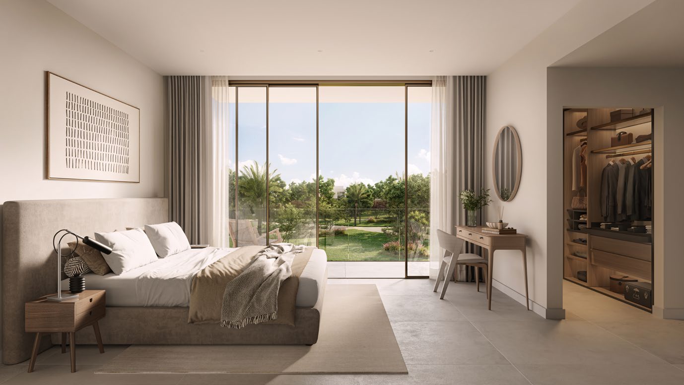 Bedroom with walk-in wardrobe and glass doors to a garden view